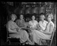 Newly elected president of the Los Feliz Women's Club Mrs. Katherine G. Cornell seated at a table with other club members, Los Angeles, 1935