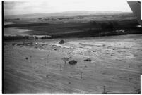 Aerial view of rushing flood waters destroying homes in North Hollywood, Los Angeles, 1938