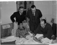 Dr. W.L. Carver with boxer Ceferino Garcia, his manager George Parnassus, and Everett Saunders from the State Athletic Commission, Los Angeles, 1940