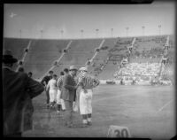 Coach and referee during college football game between the UCLA Bruins and Loyola Marymount Lions at the Coliseum, Los Angeles, circa 1935