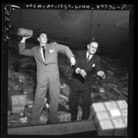 Ronald Reagan and postmaster Michael Fanning sorting Christmas packages, Los Angeles, Calif., 1949