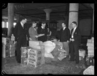 Unidentified men wearing business suits in a cooperative warehouse, Los Angeles, 1930s