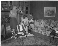 Group of young women read books and write together at their USC sorority house, Los Angeles, 1940