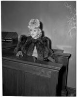 Mae West sitting in court during questioning about earnings from her role in the movie "She Done Him Wrong," Los Angeles, 1940