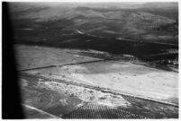 Aerial view of rushing flood waters moving down the Los Angeles River in North Hollywood, Los Angeles, 1938