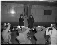 Betsey Cushing Roosevelt being photographed with attorney Basil O'Connor and brother Henry K. Cushing, Los Angeles, February 29, 1940