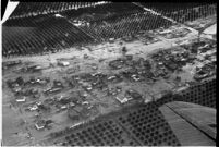 Aerial view of rushing flood waters destroying homes and crops in North Hollywood, Los Angeles, 1938