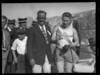 "Fastest Man Alive" and 100-meter gold medalist Charlie Paddock stands with A.A.U. chief Robert Weaver and revelers, 1920s