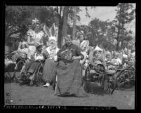 Children in wheelchairs hunting for eggs at Los Angeles' Orthopaedic Hospital Easter hunt in 1946