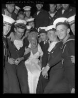 Actress Betty Hutton with Canadian sailors on board HMCS Ontario, 1949