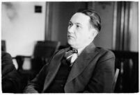 Widower Robert S. James sitting in a courtroom during an inquest involving his wife's death, Los Angeles, 1935