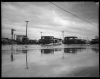 Vehicles cross flood waters at Manchester and Central, Los Angeles, March 1935