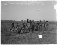 Soliders hold up 160th Infantry flag during a military show for National Defense Week, Los Angeles, 1940