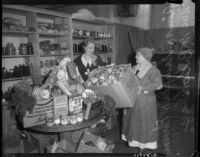 Aimee Semple McPherson and Mrs. M. B. Godbey in a pantry preparing food baskets, Los Angeles, 1935