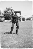 LA Daily News city editor Charles Judson demonstrates improper golf swings for a tutorial series with golfer Fay Coleman. Circa 1940