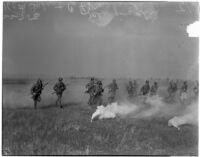 Soliders of the 160th Infantry charge through a smoke screen during a military show for National Defense Week, Los Angeles, 1940