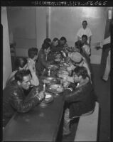 Undocumented Mexican workers eat a meal before deportation, Los Angeles, 1952