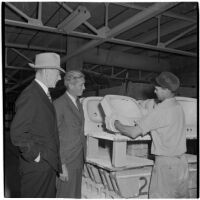 R. E. Davis and factory manager W. Fulton inspecting a completed ceramic sink at the Universal Vitreous China Factory, Mentone, circa 1948