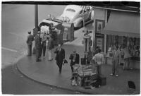 Aerial view of pedestrians and Owl Drug on the corner of Hollywood and Vine, Los Angeles, 1940