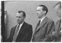 Murder suspect Robert S. James standing between two unidentified men in court, Los Angeles, 1936