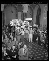 Young Republicans members waving states' delegates signs in aisle of chamber as people watch presidential election results Los Angeles, Calif., 1952