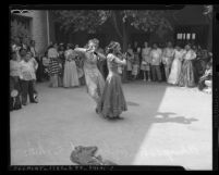 Crowd watching two dancers at the 1945 Los Angeles Filipino Fiesta