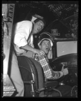 Comedians Dean Martin and Jerry Lewis mugging it up in cockpit of airplane, circa 1950