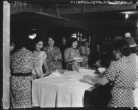 Mexican American women prepare food for flood victims