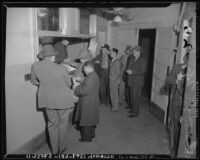 Japanese nationals board bus for evacuation and relocation, California, 1942