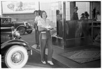 Drive-in waitress carrying a tray, Los Angeles, 1937