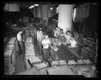 Male workers sorting packages at Terminal Annex Post Office in Los Angeles, Calif., circa 1947