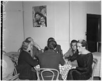 Female impersonator Johnnie David and five others seated at a table smoking and drinking, Hollywood, circa 1937