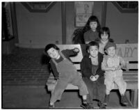 Children sit on a bench in Chinatown, Los Angeles, 1930s