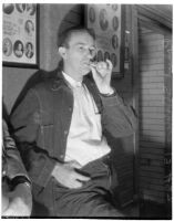 Unidentified detective keeping guard by murderer Robert S. James's jail cell, Los Angeles, 1936