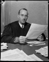 Judge Irvin Taplin looking over paperwork, Los Angeles, 1936