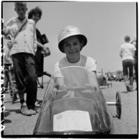 Al Pedrosa smiling in his soap box derby car, Los Angeles, 1946