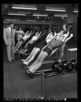 Vic Tanny with four women exercising at his gym Vic Tanny's Gym in Los Angeles, Calif., circa 1953