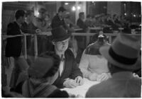 Patrons playing cards in a casino, Los Angeles, 1937