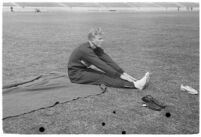 USC track athlete stretching on the field at the Coliseum, Los Angeles, 1937