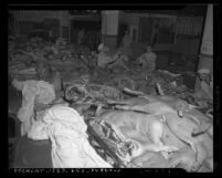 Male workers in delivery area of a meat packing plant in Los Angeles, Calif., circa 1945