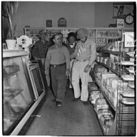 A. Anton and others in a convenience store during Anaheim's annual Halloween festival, Anaheim, October 31, 1946