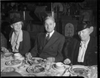 William Gibbs McAdoo at dinner event with two unknown women