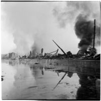 Damage done to a marine terminal after the Markay oil tanker exploded in L.A. Harbor, Los Angeles, 1947