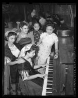 Five women in ethnic costumes at piano during the 1945 Los Angeles Filipino Fiesta