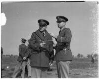 Colonel Holden and Captain Smith stand together during a military show for National Defense Week, Los Angeles, 1940