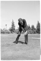 LA Daily News city editor Charles Judson demonstrates improper golf swings for a tutorial series with golfer Fay Coleman. Circa 1940