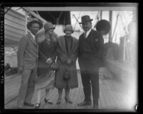 Race car drivers, Earl Cooper and Barney Oldfield with their wives on deck of ship, circa 1926