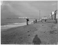 Beachgoers examine high tides at a Los Angeles beach, December 1937