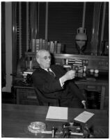 Republican politician Arthur M. Hyde sitting at a desk, Los Angeles, 1940