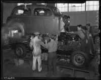 Men at work at the Los Angeles Studebaker assembly plant in Vernon, CA. Circa January 2, 1936